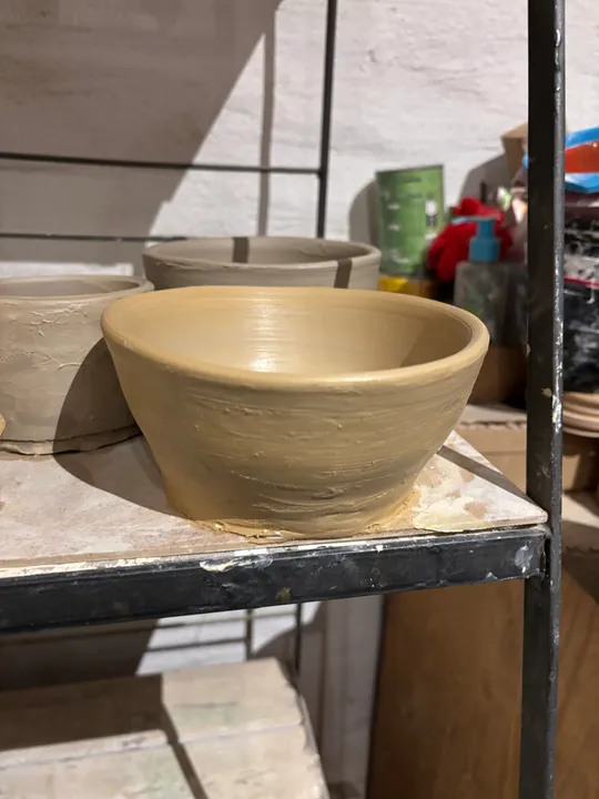 Tontopf auf Regal im Töpferstudio.