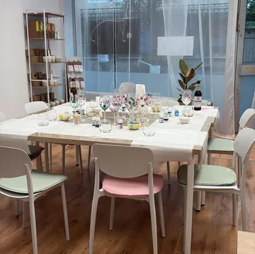 Decorated table with wine glasses in a bright room.