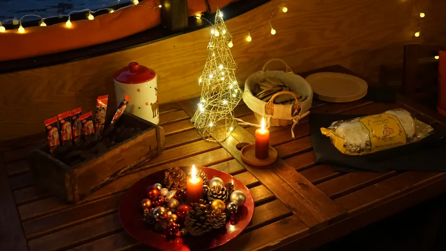 Christmas decorations with candles on a wooden table.