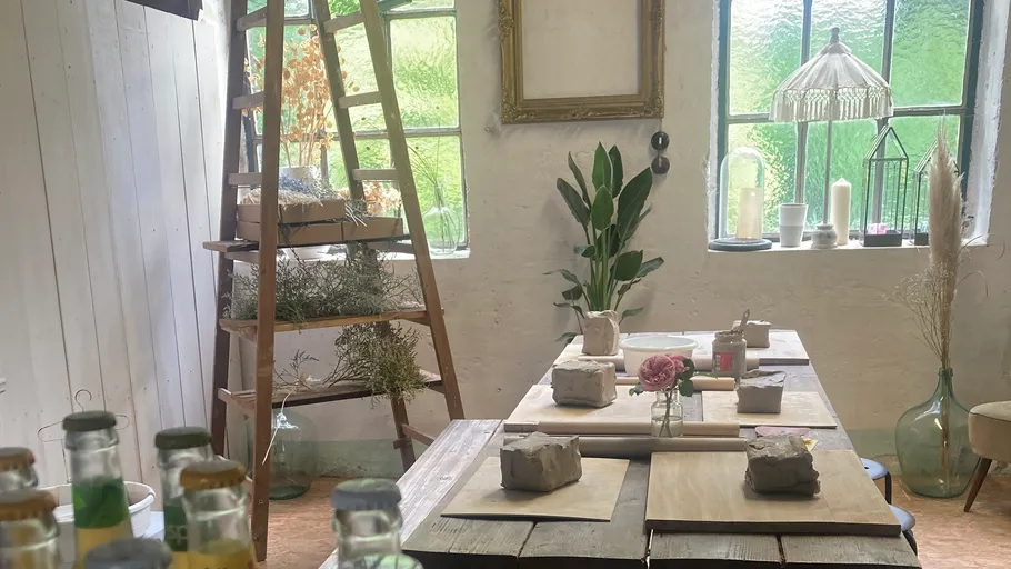 Artistic studio with clay on a wooden table.