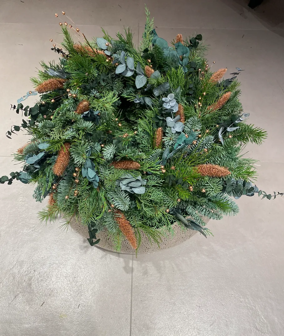 Green wreath on a light floor surface.