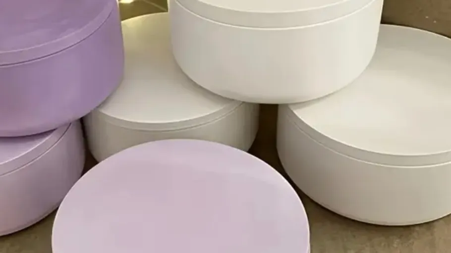 Round storage boxes stacked, two colors.