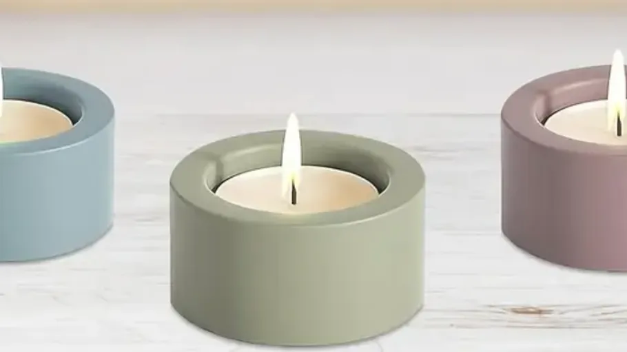 Three tealight candles in colored holders.