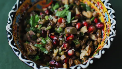 Colorful salad with pomegranate in decorative bowl.