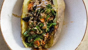 Stuffed potato with vegetables on plate