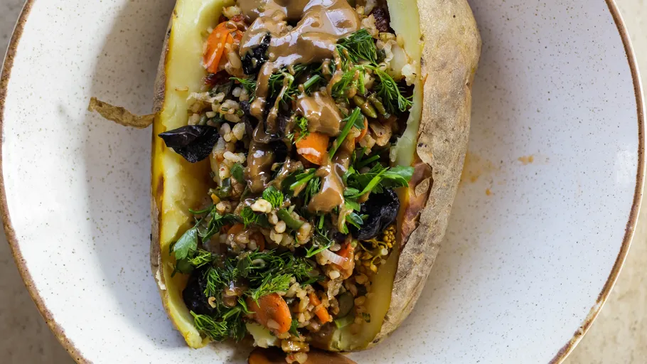 Stuffed potato with vegetables on plate