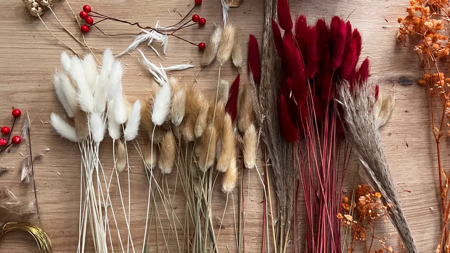 Assorted dried flowers on a wooden table.