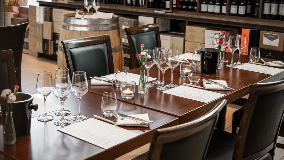 Table setting with glasses in a wine cellar.