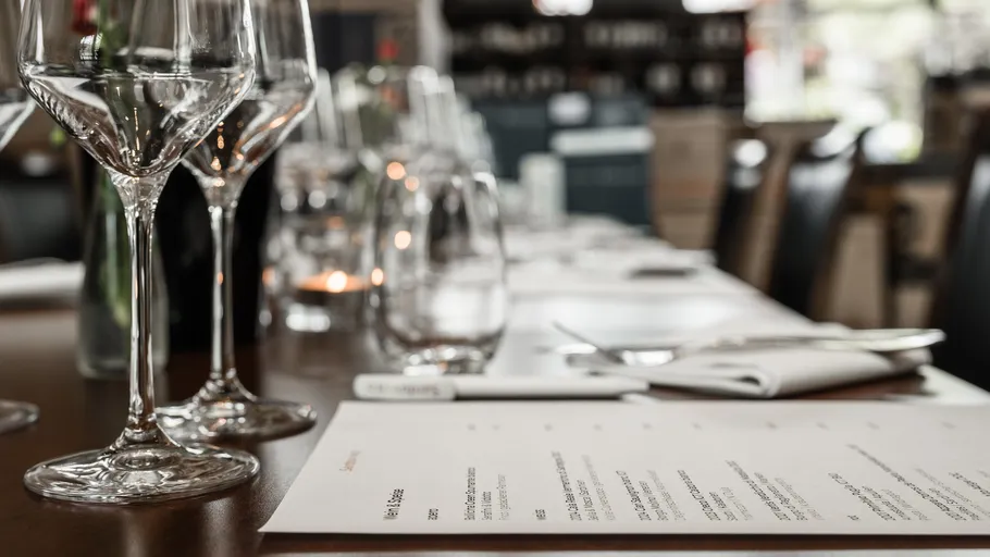 Wine glasses on a restaurant table setting.