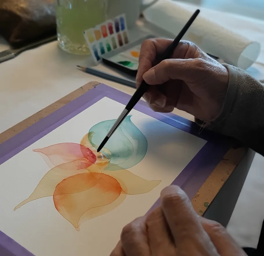 Hand painting watercolor leaves on paper.