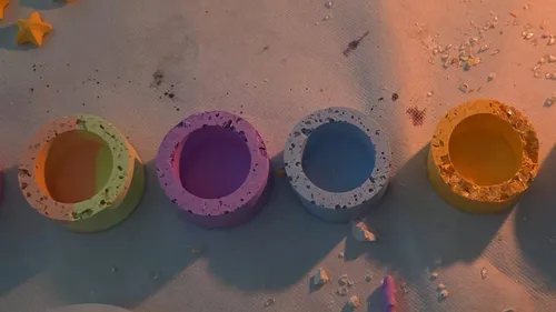 Colorful concrete rings on a textured surface.