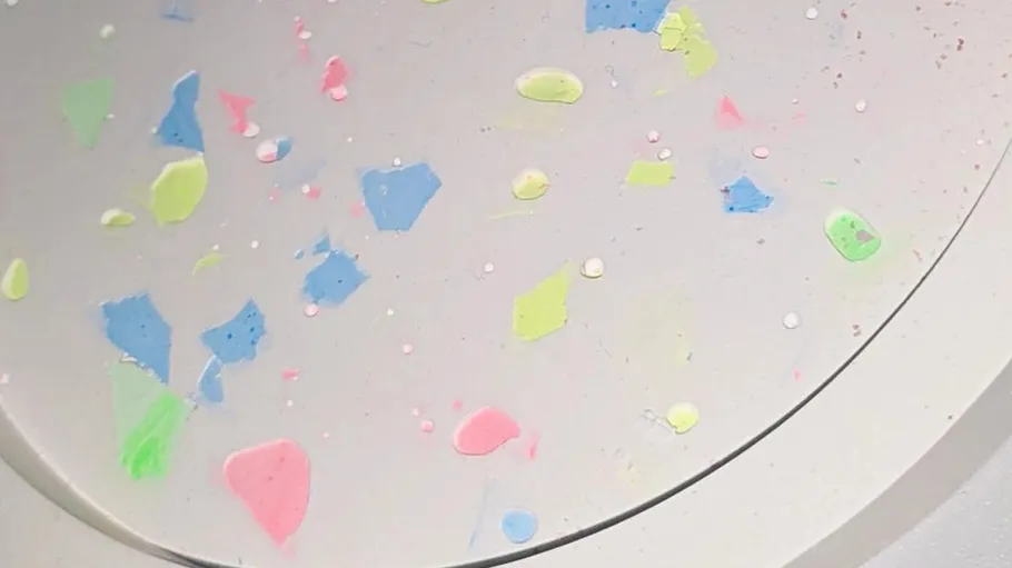 Colorful confetti scattered on a white surface.