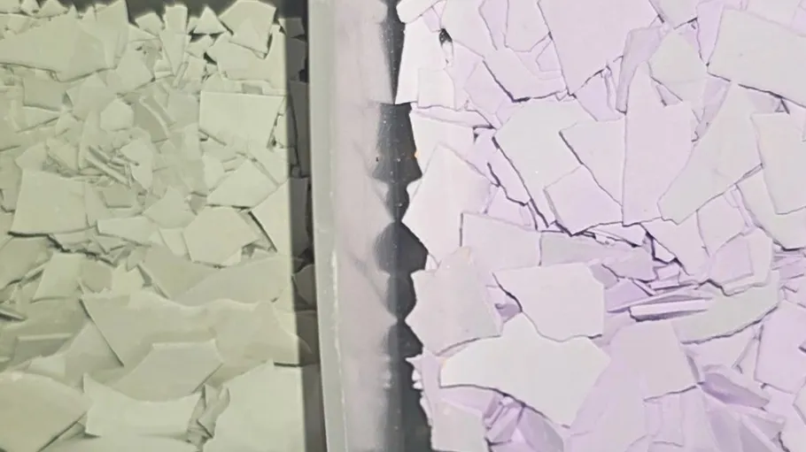 Two bins with white and purple plastic pieces.