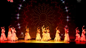 Group of dancers performing on a decorated stage.
