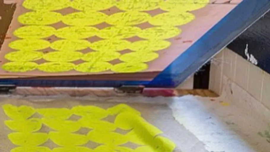 Screen-printing stencil with yellow leaf patterns.