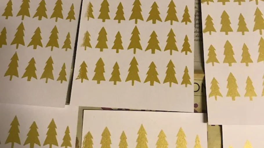 Golden trees printed on white paper.