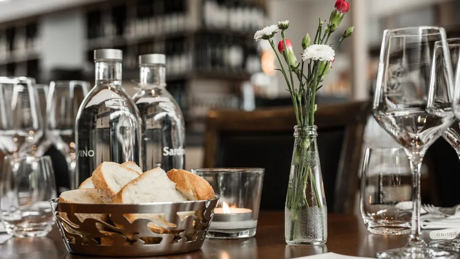 Tisch mit Brotkorb und Blumen.