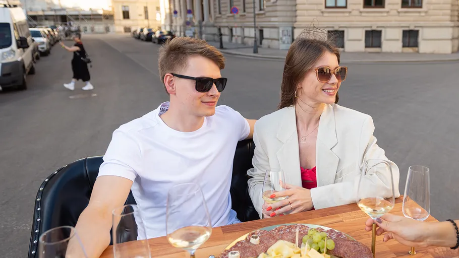 Couple enjoying drinks in a street setting.