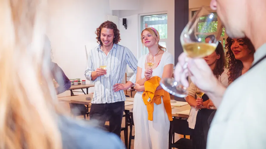 People socializing with drinks in a room.