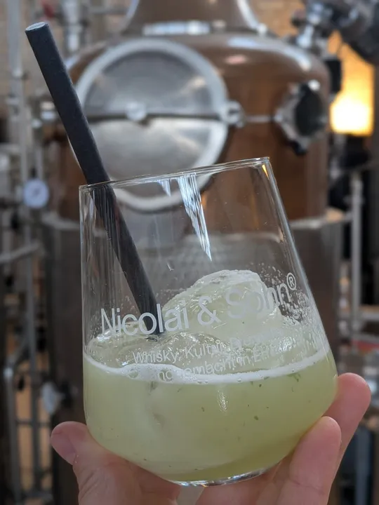 Glass with cocktail in a distillery.