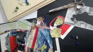 Collage materials on a crafting table.