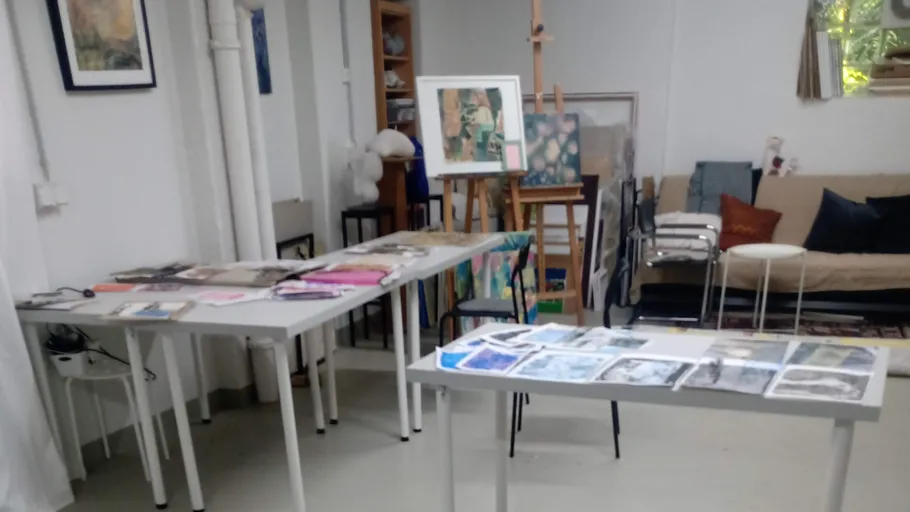 Artworks displayed on tables in a studio.