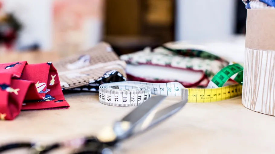 Sewing tools and fabric on a table.