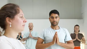 Group practicing yoga in a studio.