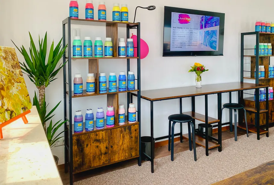 Art studio with painting supplies and seating.