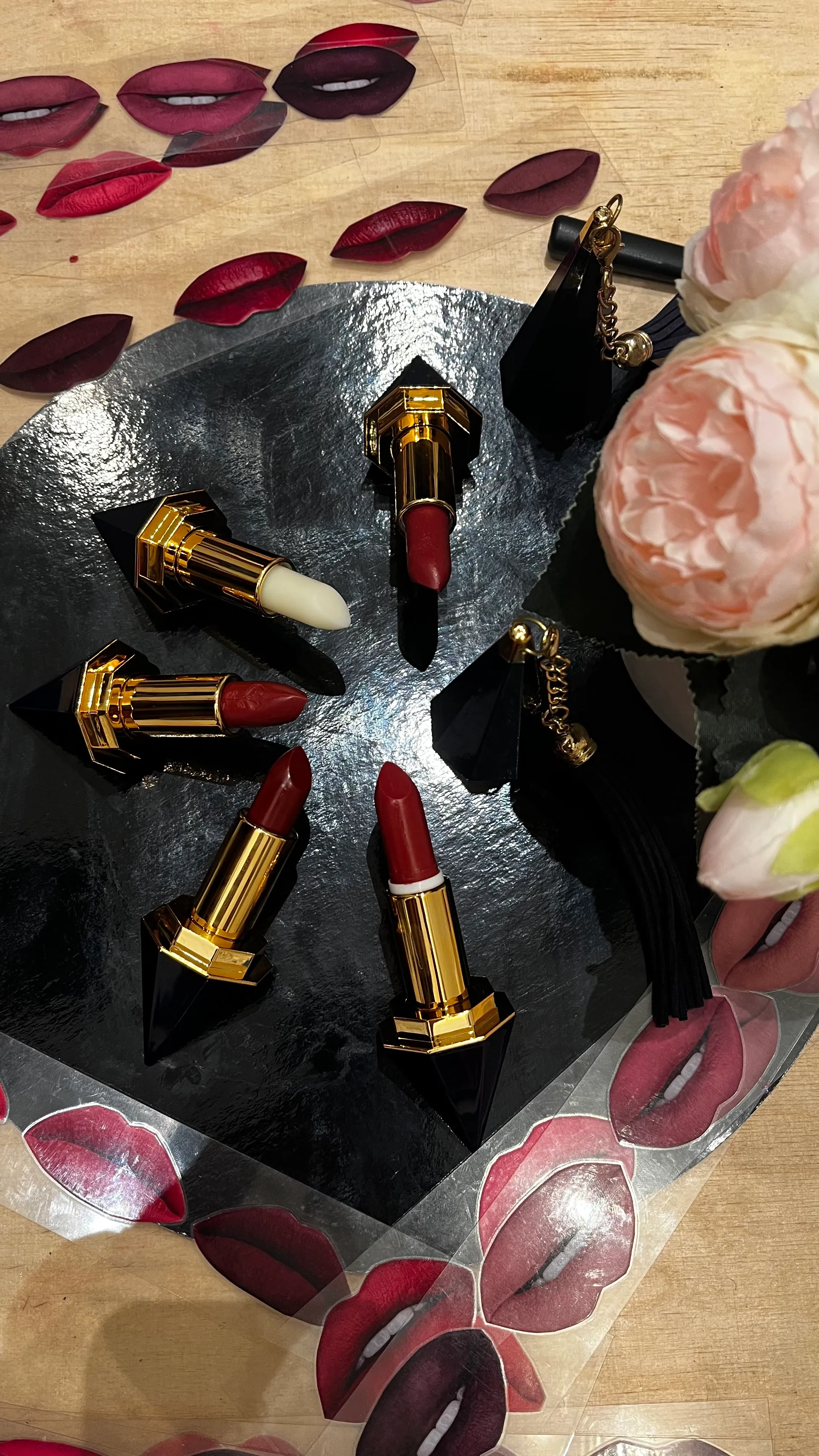 Lipsticks arranged on heart-shaped black cloth.