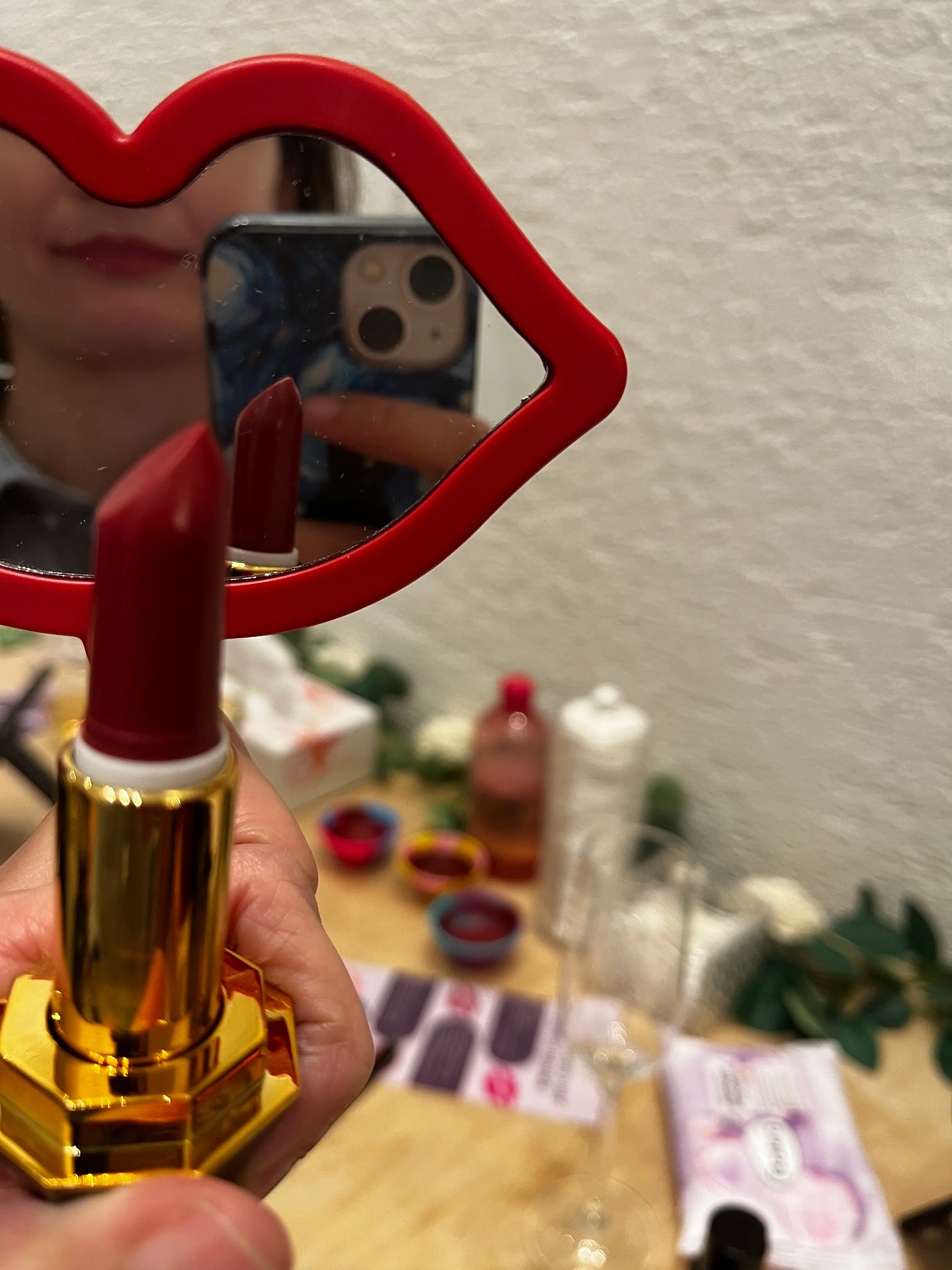 Red lipstick and mirror in a room.