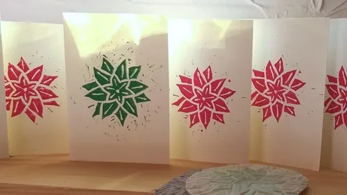 Homemade cards with red and green star designs.