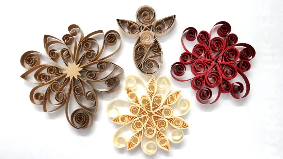 Paper quilling snowflakes and angel, white background.