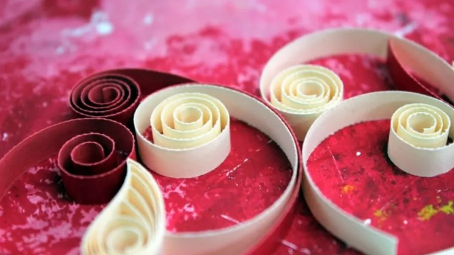 Rolled paper spirals on red background.