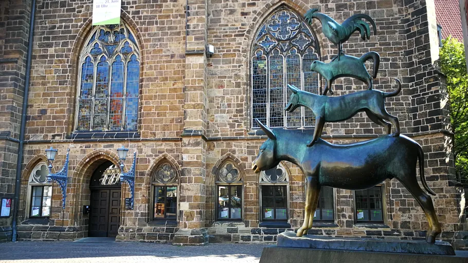 Animal statue in front of historic building.
