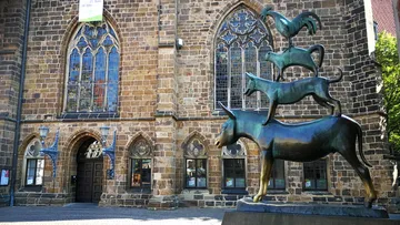 Animal statue in front of a historic building.