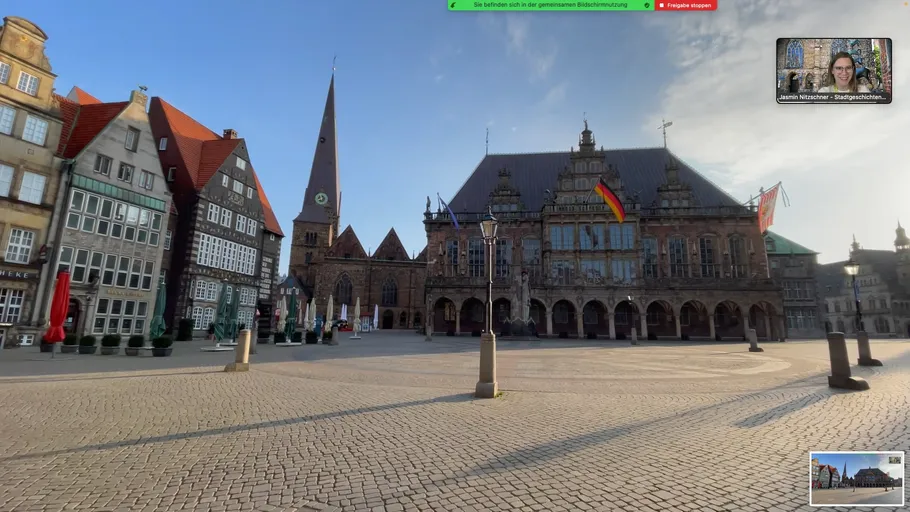 Historic buildings in a sunny European square.