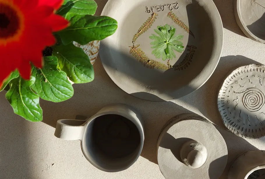 Handcrafted pottery with decorative plant design.
