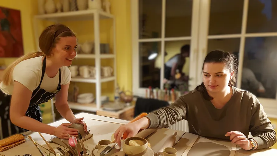 Two women setting the table in kitchen.