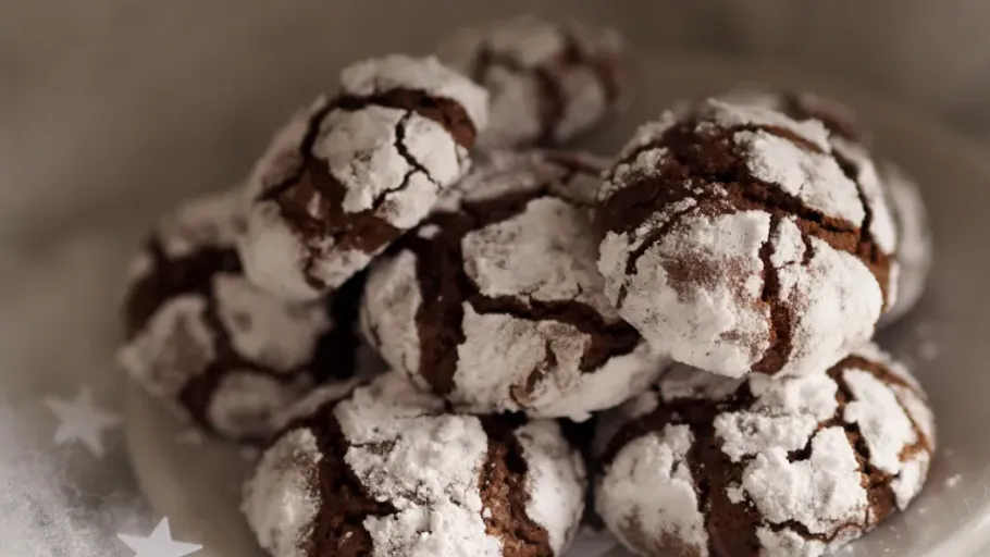 Chocolate cookies dusted with powdered sugar.