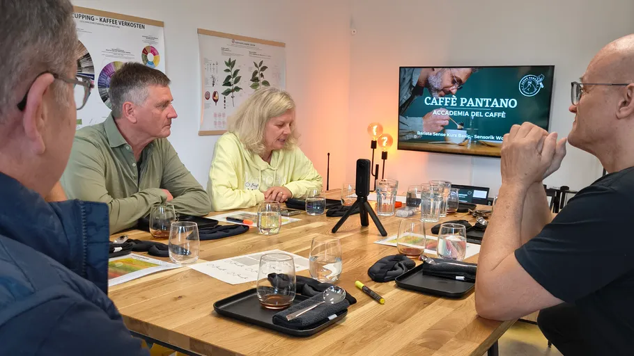 People tasting coffee at a workshop.