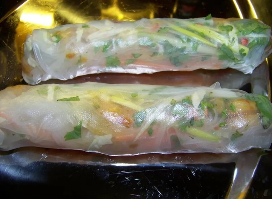Two rice spring rolls on a plate.