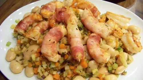 Bacon-wrapped shrimp on bean and vegetable bed.