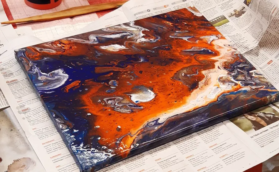 Abstract painting drying on newspaper.