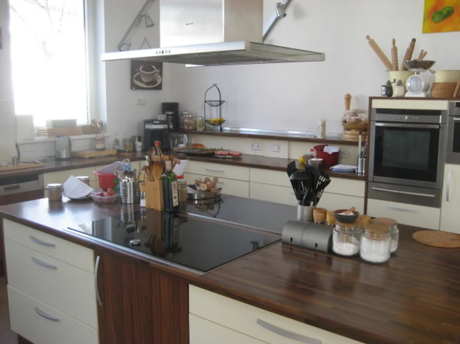 Modern kitchen with wooden countertops and utensils.