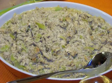 Casserole with creamy topping in white dish.