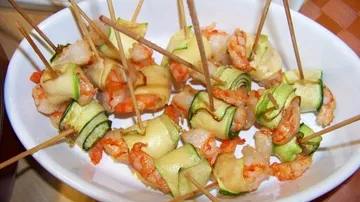 Shrimp wrapped in zucchini in a bowl.