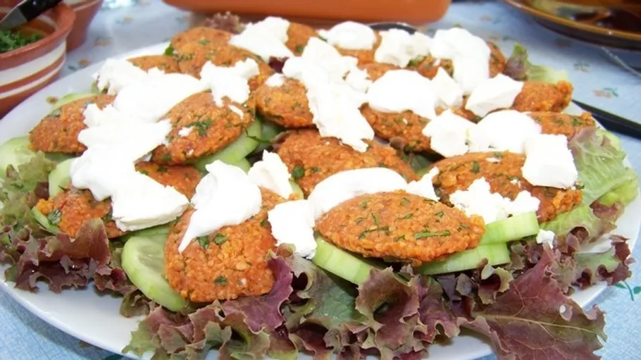 Bulgur patties with cheese on lettuce.
