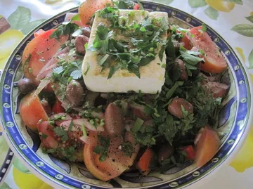 Greek salad with feta cheese and olives.