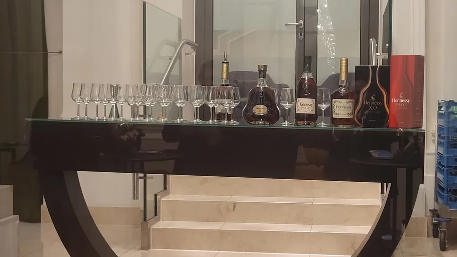 Wine bottles and glasses on modern table.